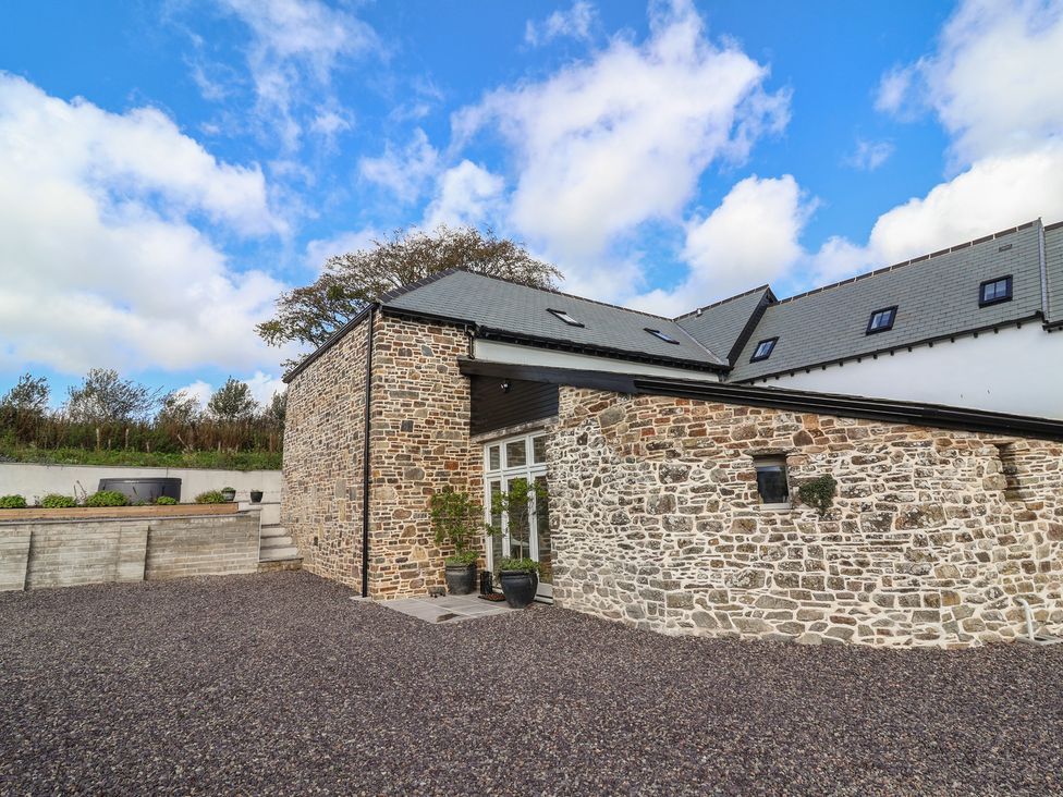 An outdoor view of a stone building at The Granary in Chelfham near Barnstaple