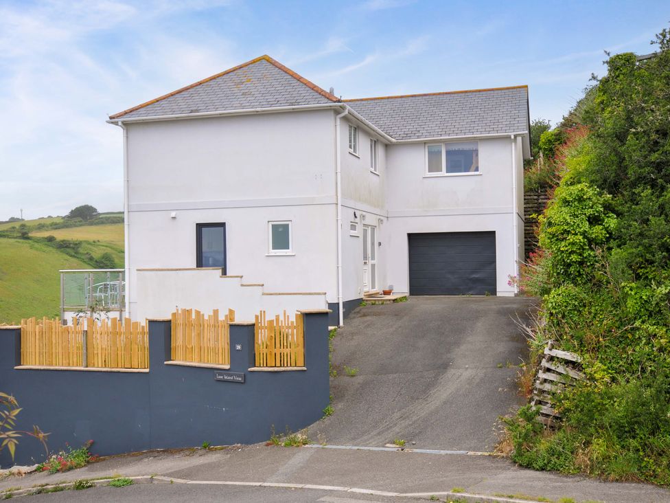 A house with a garage and driveway at Looe Island View in Downderry
