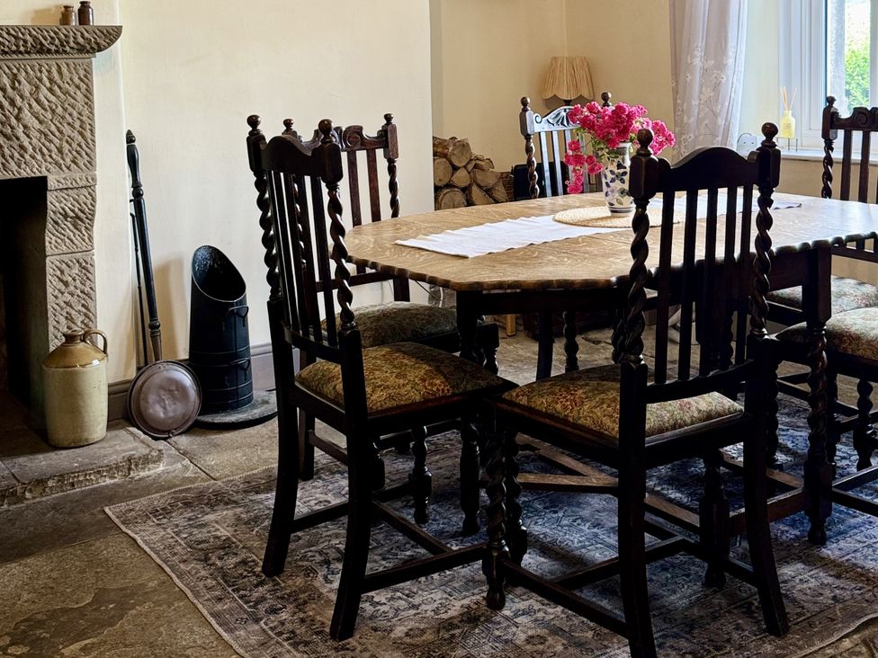 A dining room with a table and chairs at Hope View House Castleton, Peak District