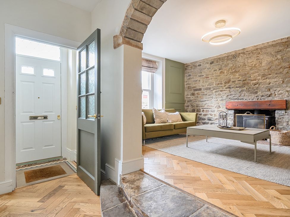 A living room with a front door and sofa at Hillside House Aysgarth near West Witton