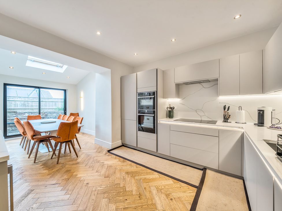 A kitchen with dining area and modern appliances at Hillside House Aysgarth near West Witton