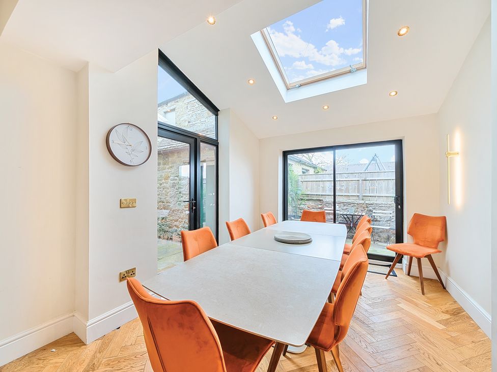 A dining room with a long table and chairs at Hillside House in Aysgarth near West Witton