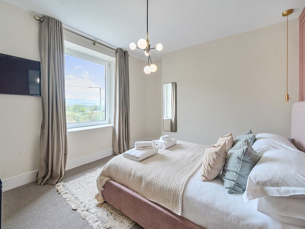 A bedroom with a bed and window at Hillside House Aysgarth near West Witton
