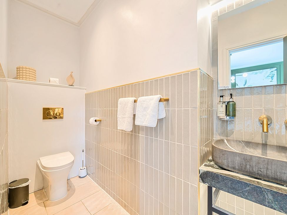 A bathroom with a sink, toilet, and towels at Hillside House Aysgarth near West Witton