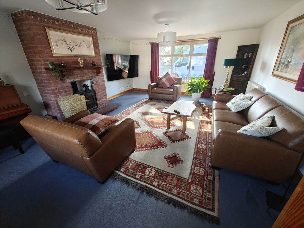 A living room with sofas and a television at Ninevah in Balquhidder, Perthshire, Scotland