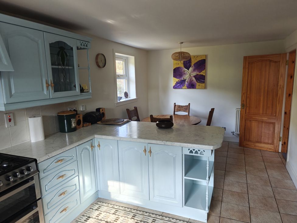 A kitchen with a table and chairs at Ninevah in Balquhidder, Perthshire, Scotland