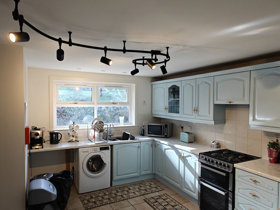 A kitchen with appliances and cabinets at Ninevah, Balquhidder, Perthshire, Scotland