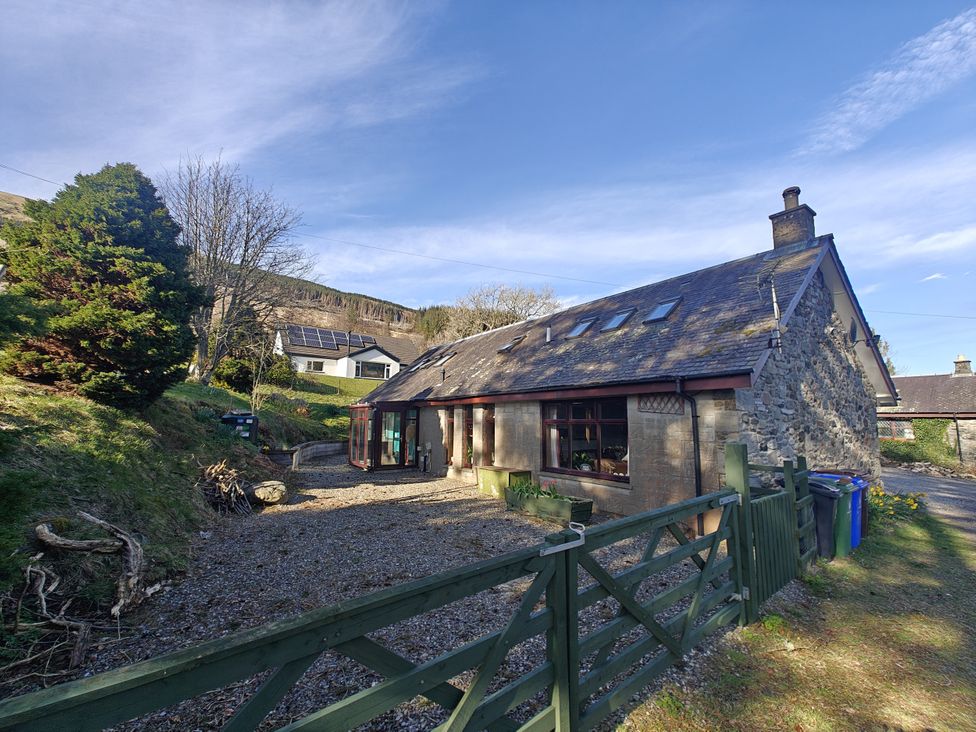 A house with stone walls and a garden at Ninevah in Balquhidder, Perthshire, Scotland