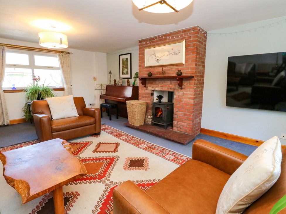 A living room with a seating area and fireplace at Ninevah Balquhidder, Perthshire, Scotland