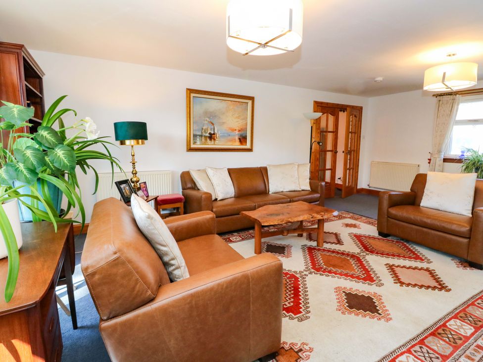 A living room with sofas and a coffee table at Ninevah in Balquhidder, Perthshire, Scotland