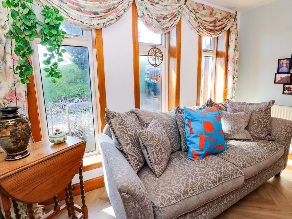 A living room with a sofa and table at Ninevah in Balquhidder, Perthshire, Scotland