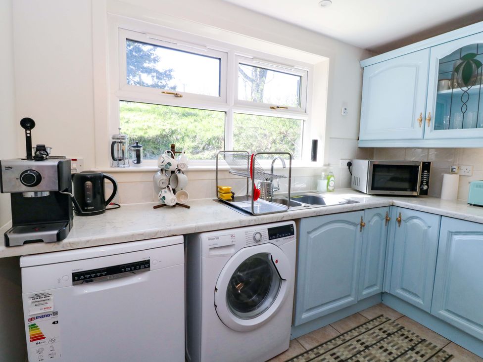 A kitchen with appliances including a dishwasher and coffee machine at Ninevah, Balquhidder, Perthshire, Scotland