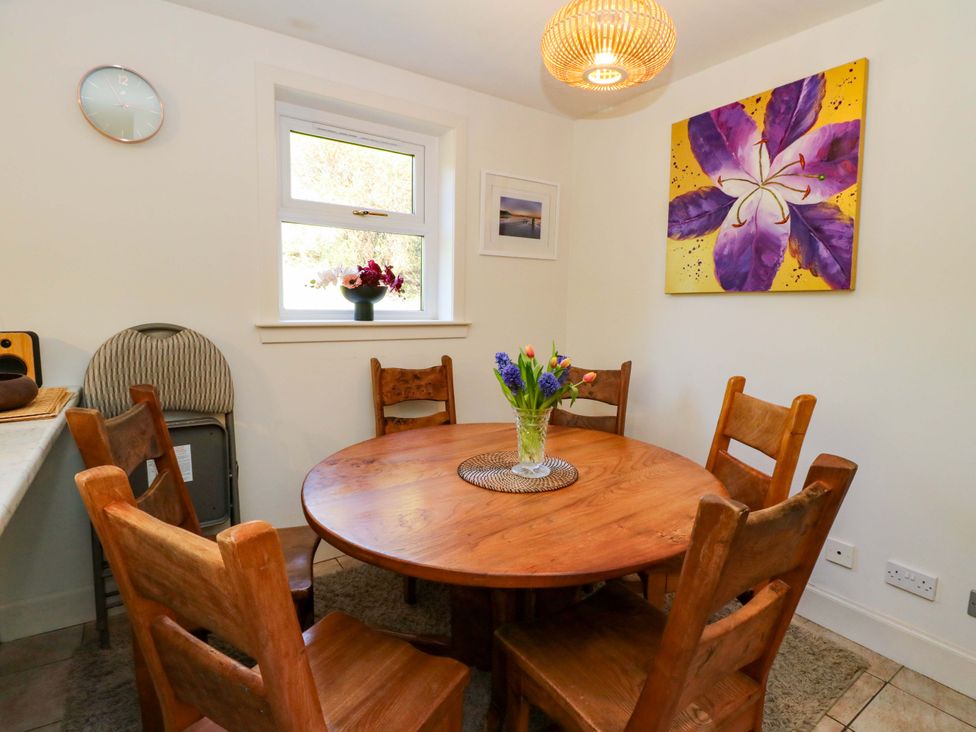 A dining room with a wooden table and chairs at Ninevah, Balquhidder, Perthshire, Scotland