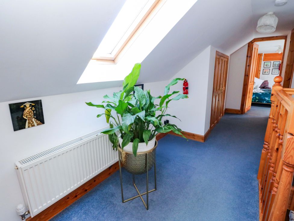 A hallway with a plant and artwork at Ninevah in Balquhidder, Perthshire, Scotland