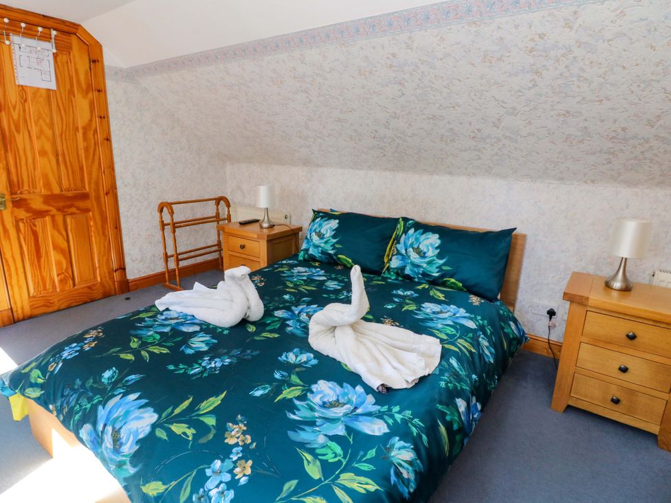 A bedroom with a bed and bedside table at Ninevah, Balquhidder, Perthshire, Scotland