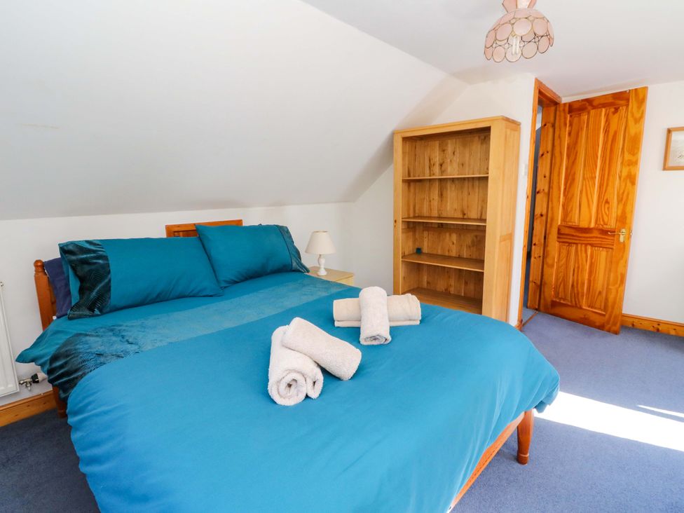 A bedroom with a bed and shelving unit at Ninevah in Balquhidder, Perthshire, Scotland