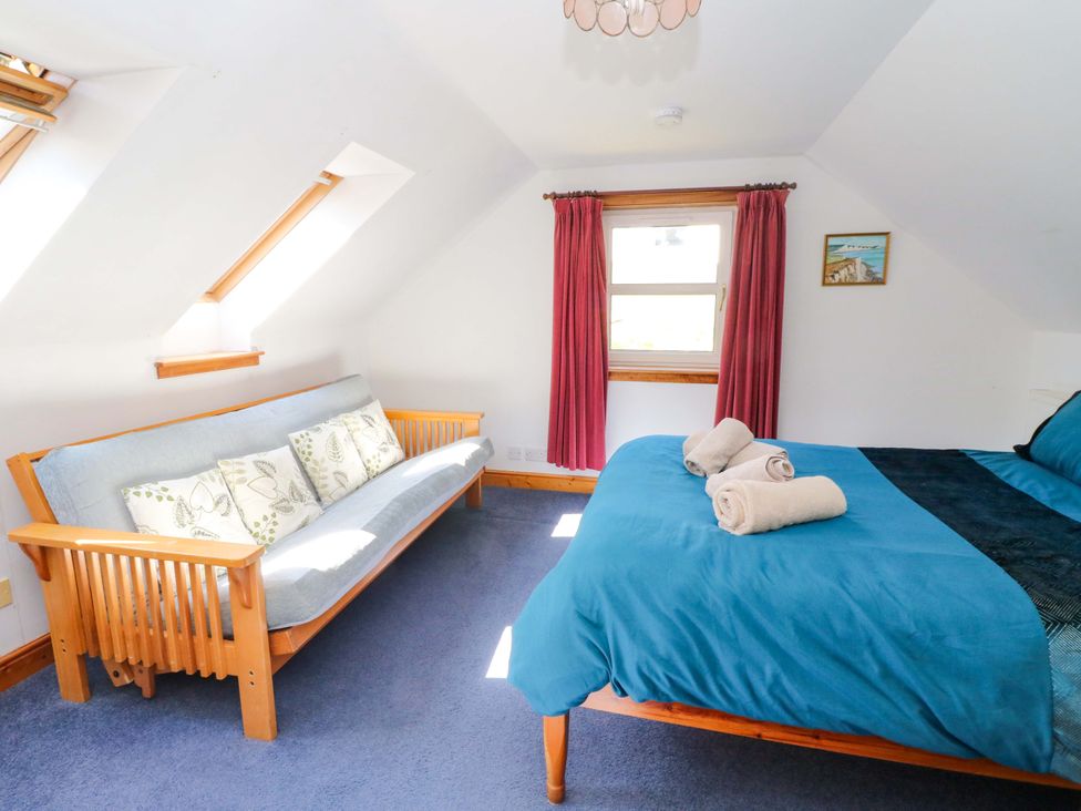 A bedroom with a bed and a sofa at Ninevah, Balquhidder, Perthshire, Scotland