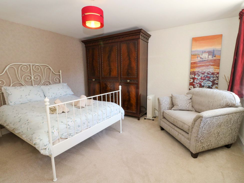 A bedroom with a bed and wardrobe at Ninevah in Balquhidder, Perthshire, Scotland