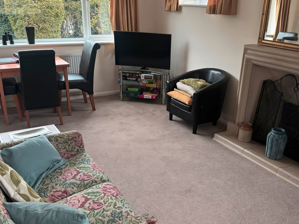 A living room with a sofa and dining table at The Garden House in Whitstable