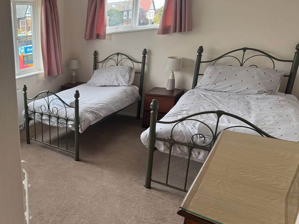 A bedroom with two beds and a lamp at The Garden House in Whitstable