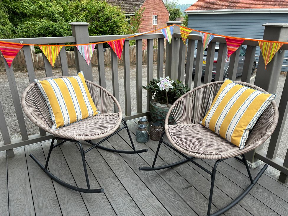 Two rocking chairs with cushions on a patio at Lyme Zest in Lyme Regis