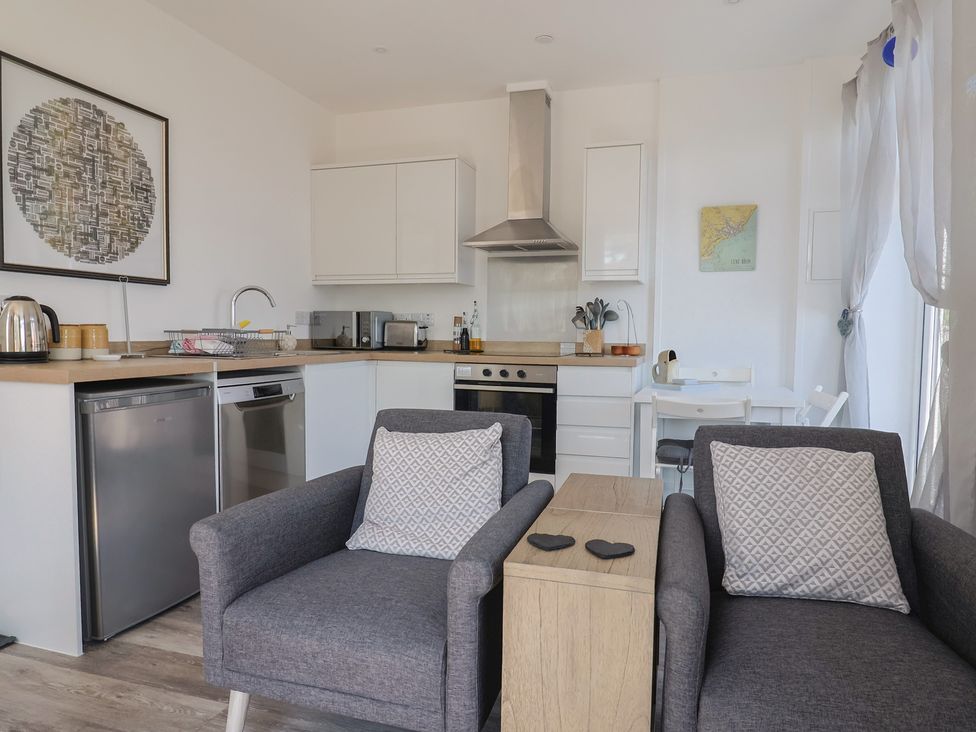 A kitchen with seating area at Lyme Zest in Lyme Regis