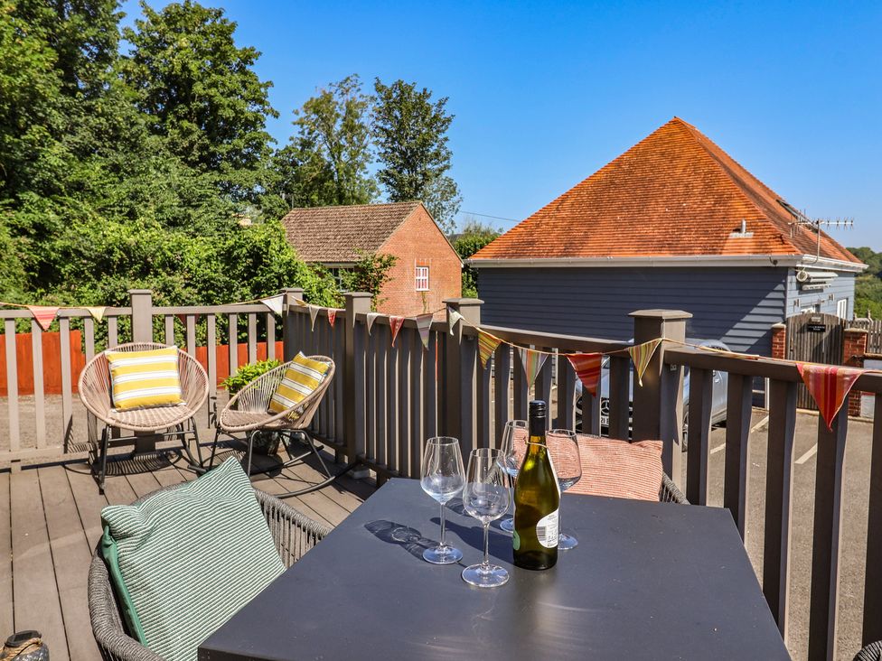 An outdoor deck with chairs and a table at Lyme Zest in Lyme Regis