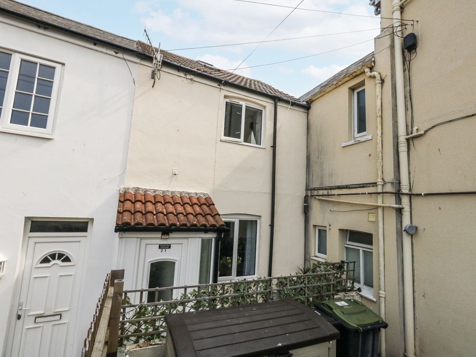 An outdoor view of buildings with a door and windows at Saddlers Cottage in Weymouth