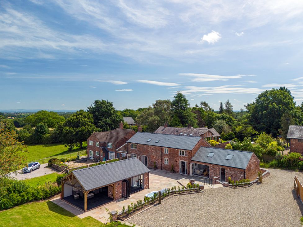 An outdoor view of a house with a garage and garden at Fairvale House