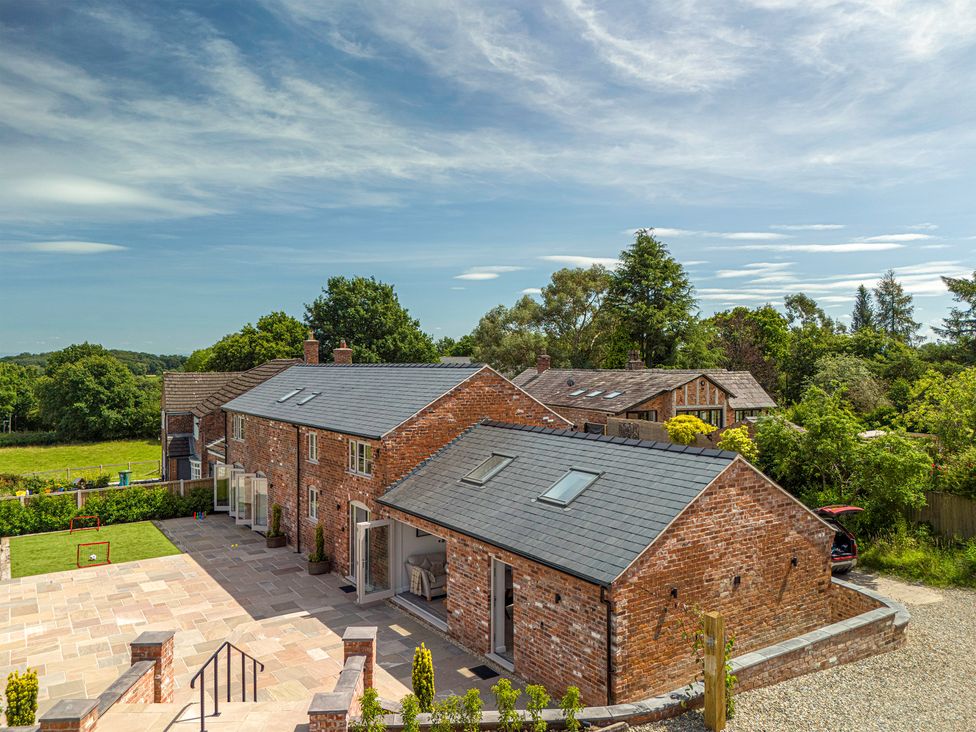 A view of multiple houses with brick walls and trees at Fairvale House