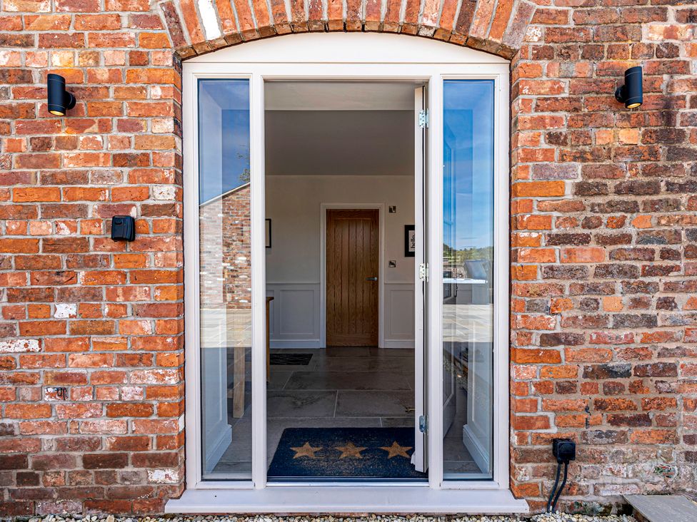 An entranceway with a door and brick wall at Fairvale House