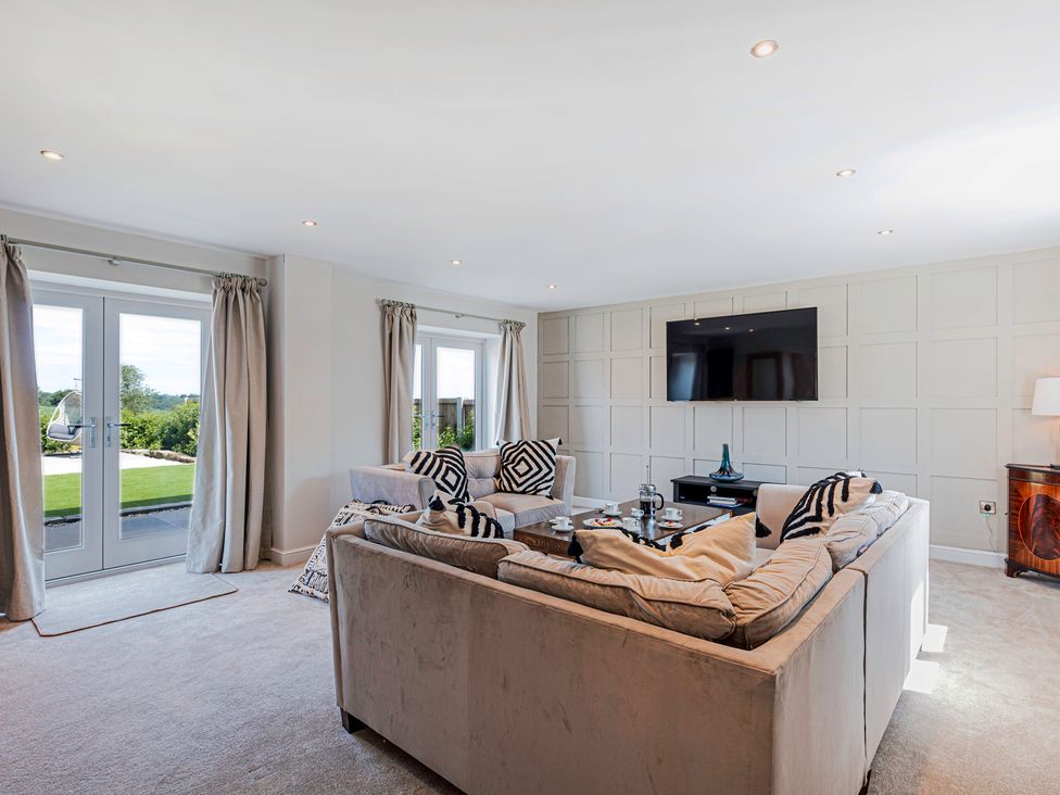 A living room with a sofa and television at Fairvale House