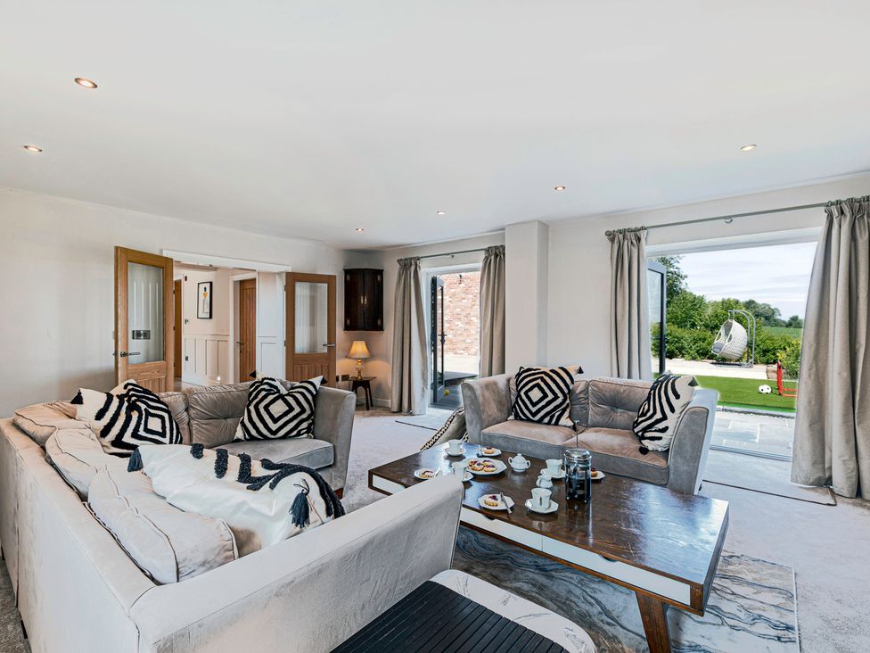 A living room with sofas and coffee table at Fairvale House