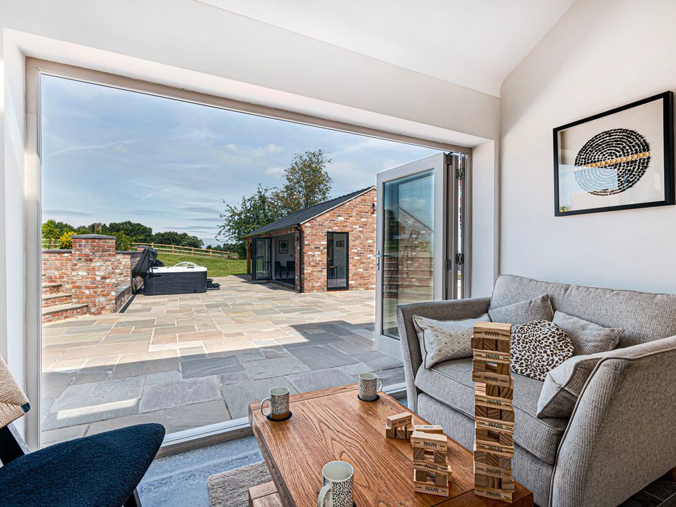 A living room with a view of an outdoor patio at Fairvale House