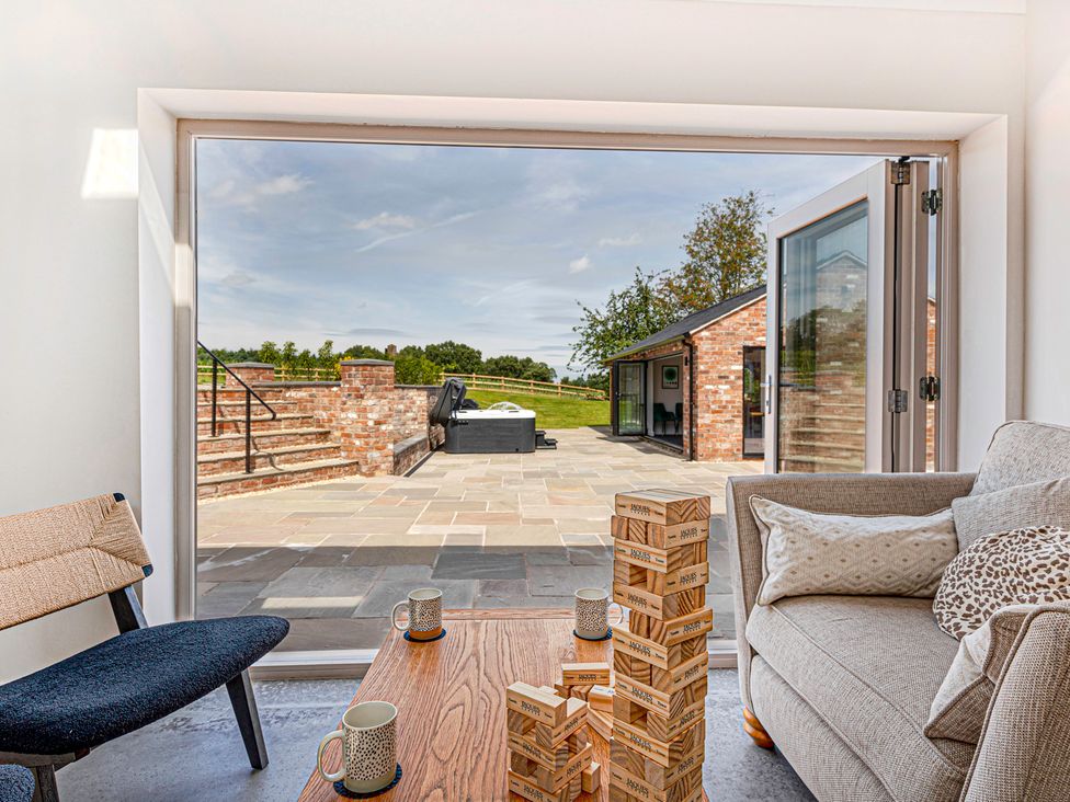 A living room with a view of an outdoor patio at Fairvale House