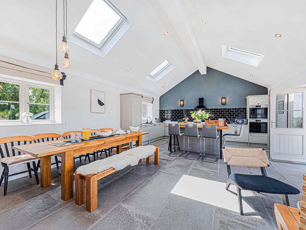 A kitchen with dining table and chairs at Fairvale House