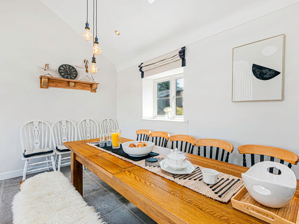 A dining room with a table set and chairs at Fairvale House