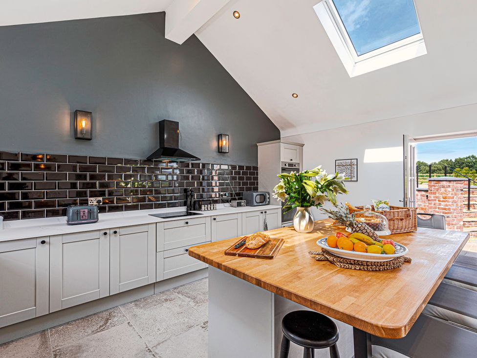 A kitchen with countertop and kitchen appliances at Fairvale House