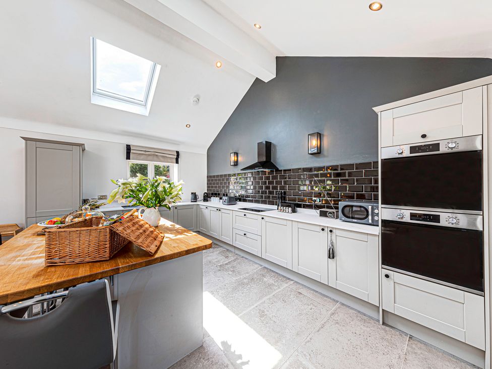 A kitchen with appliances and a skylight at Fairvale House