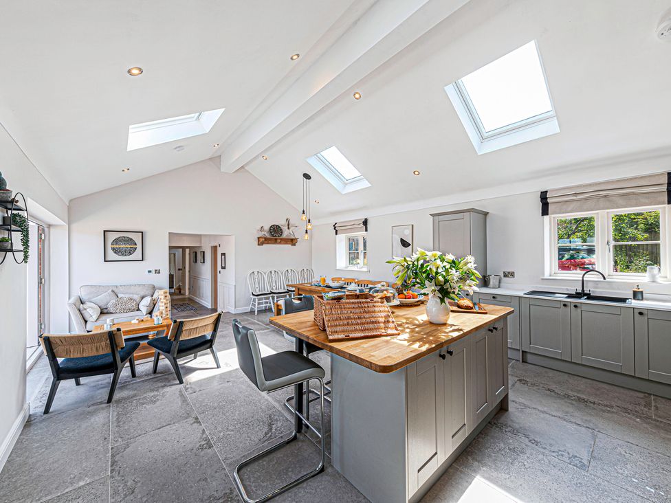 A kitchen with a dining area and skylights at Fairvale House