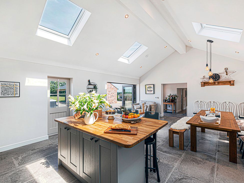 A kitchen with a wooden table and chairs at Fairvale House