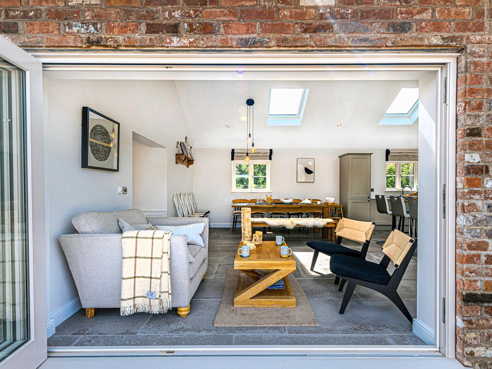 A living room with a sofa and dining table at Fairvale House