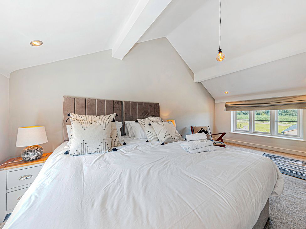 A bedroom with a bed and large window at Fairvale House