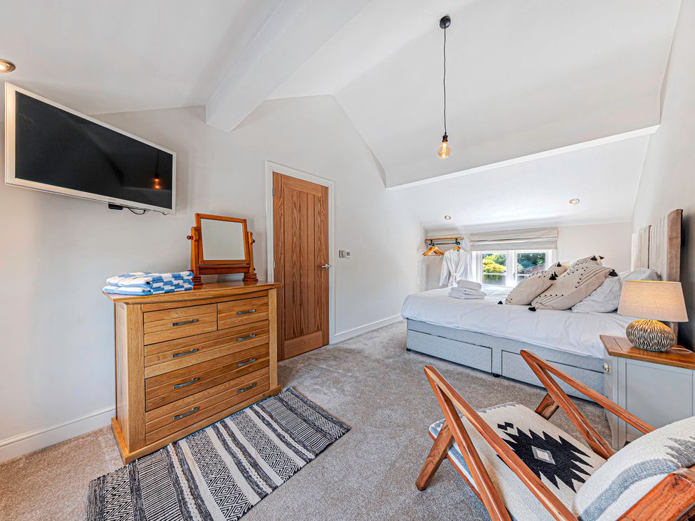 A bedroom with a bed and dresser at Fairvale House