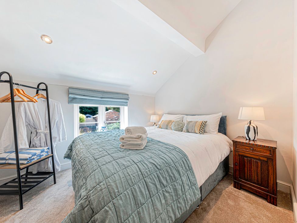 A bedroom with a bed and bedside table at Fairvale House