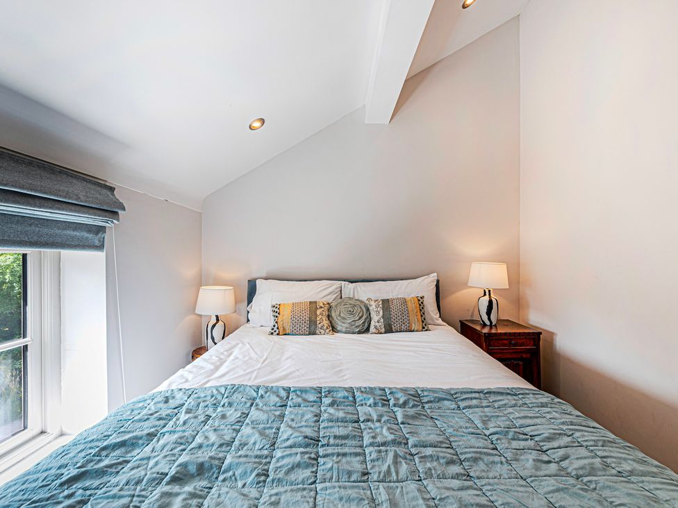 A bedroom with a bed and nightstand at Fairvale House