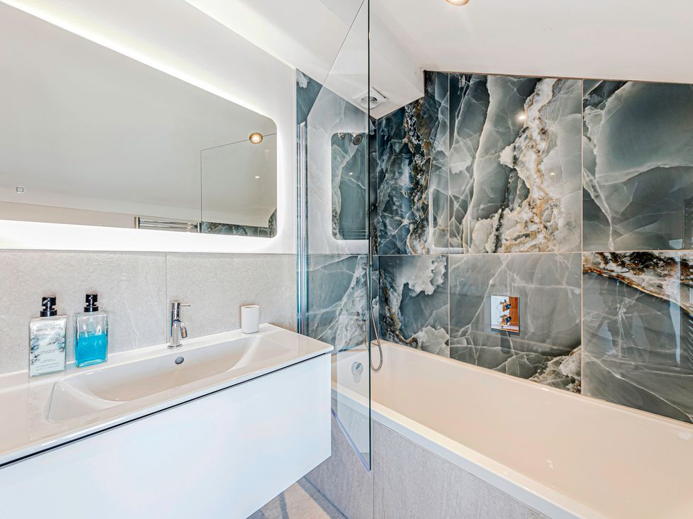 A bathroom with a bathtub and sink at Fairvale House