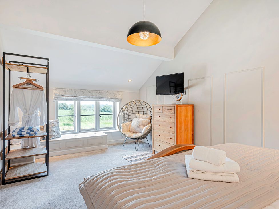 A bedroom with a bed and chair at Fairvale House 