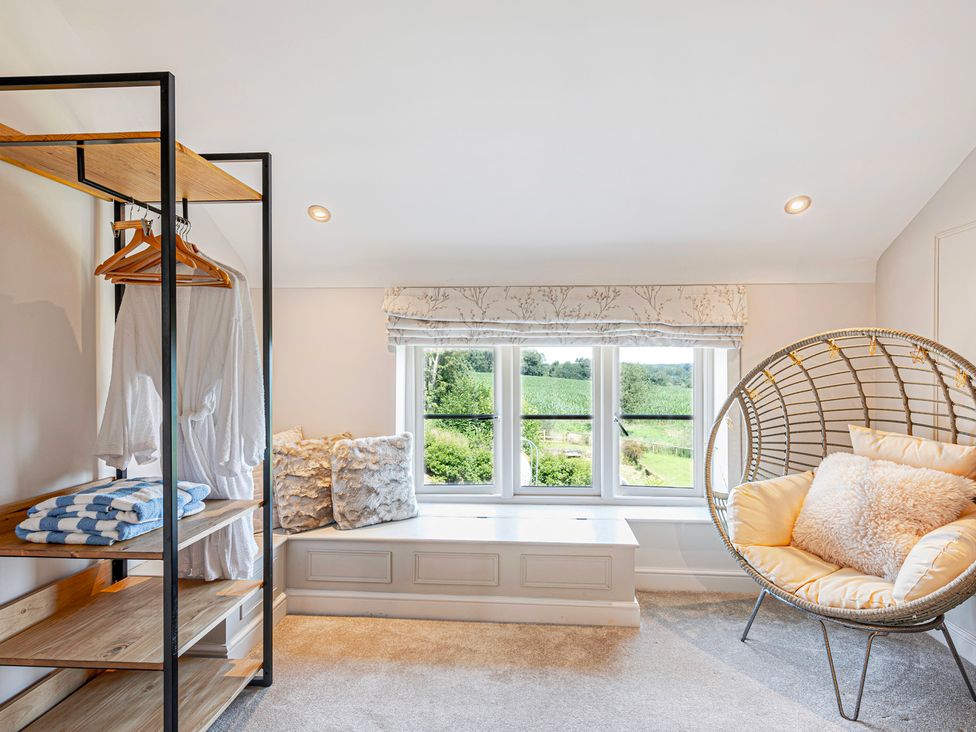 A bedroom with shelves and a hanging chair at Fairvale House
