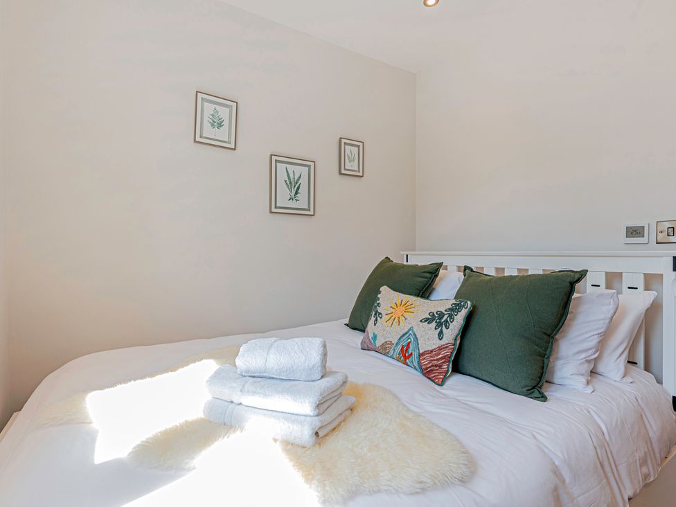 A bedroom with a bed and decorative pillows at Fairvale House